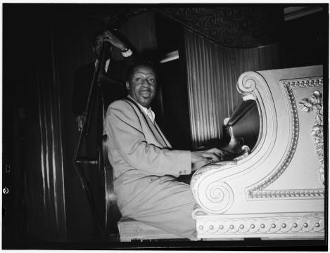 Erroll Garner seated at a piano