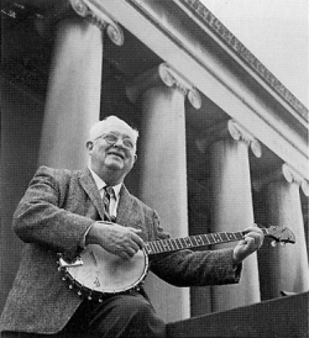 Robert Schmertz playing the banjo in front of Mellon Institute